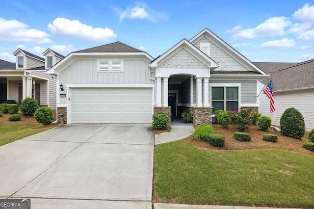 5744 Cypress Bluff Ln, Hoschton, GA 30548 - craftsman inspired home featuring stone siding, a garage, concrete driveway, a front lawn, and board and batten siding