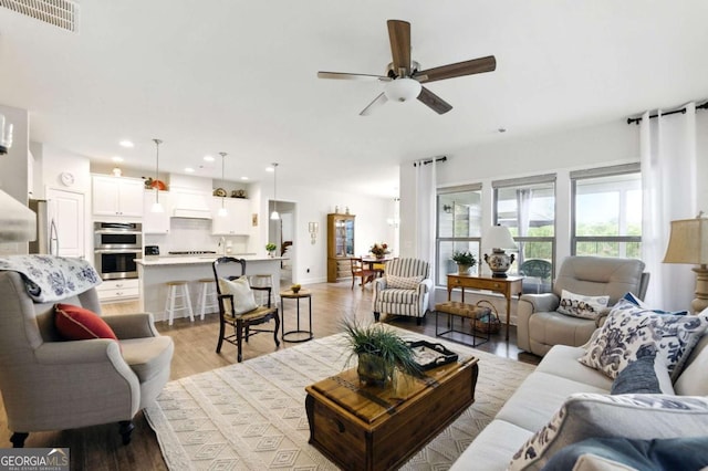 5744 Cypress Bluff Ln, Hoschton, GA 30548 - living area featuring a ceiling fan, recessed lighting, and light wood-type flooring