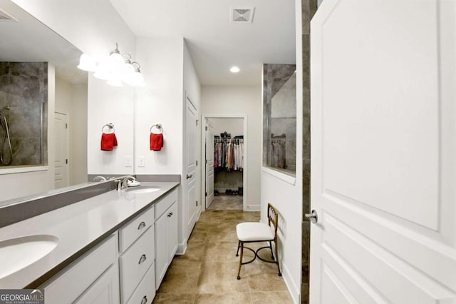 5744 Cypress Bluff Ln, Hoschton, GA 30548 - full bathroom with double vanity, a walk in closet, a tile shower, recessed lighting, and tile patterned floors