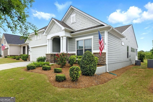 5744 Cypress Bluff Ln, Hoschton, GA 30548 - view of front of property featuring a garage, a front yard, driveway, and stone siding