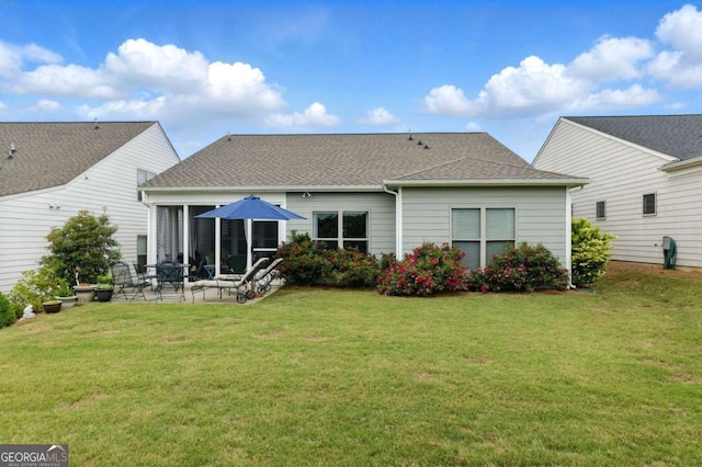 5744 Cypress Bluff Ln, Hoschton, GA 30548 - rear view of house with a patio, a yard, a sunroom, and a shingled roof