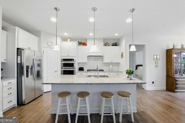 5744 Cypress Bluff Ln, Hoschton, GA 30548 - kitchen with stainless steel appliances, wood finished floors, white cabinets, and recessed lighting