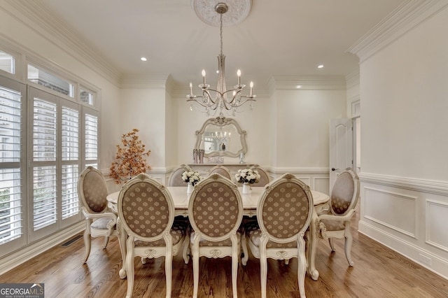 8230 Royal Melbourne Way, Duluth, GA 30097 - dining area with a chandelier, a wainscoted wall, wood finished floors, crown molding, and recessed lighting