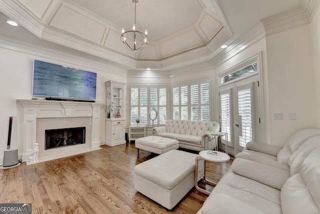 8230 Royal Melbourne Way, Duluth, GA 30097 - living room with coffered ceiling, crown molding, a chandelier, a fireplace, and wood finished floors