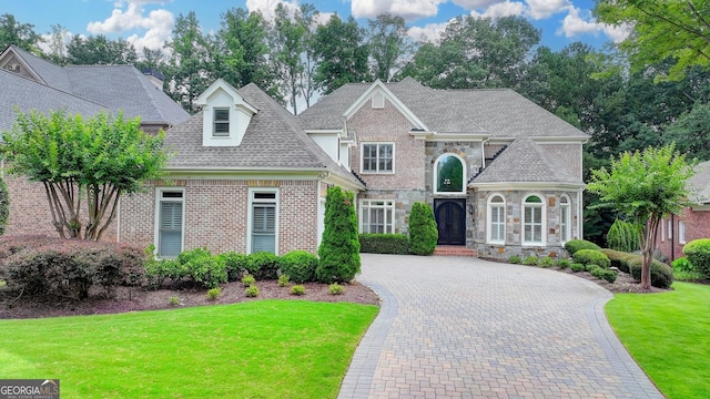 8230 Royal Melbourne Way, Duluth, GA 30097 - view of front facade with a front yard, stone siding, decorative driveway, and a shingled roof