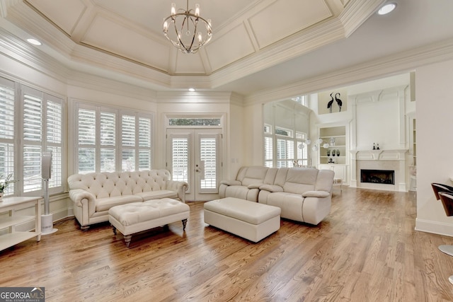 8230 Royal Melbourne Way, Duluth, GA 30097 - living room with crown molding, a chandelier, a fireplace, coffered ceiling, and french doors