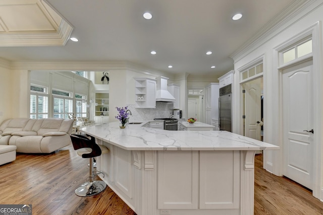 8230 Royal Melbourne Way, Duluth, GA 30097 - kitchen with custom exhaust hood, premium appliances, open shelves, crown molding, and a peninsula