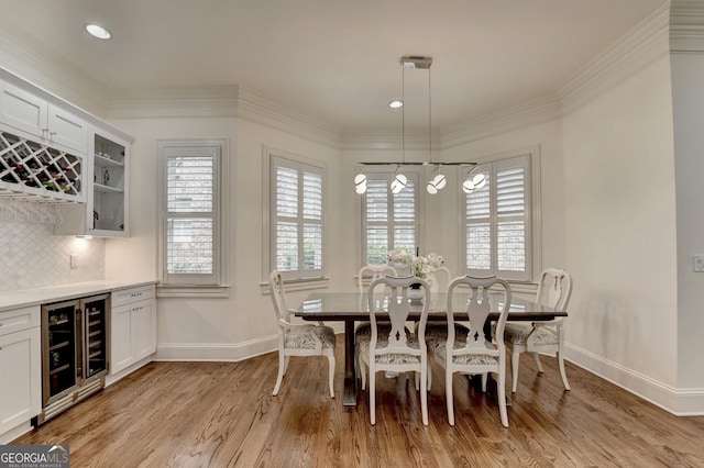 8230 Royal Melbourne Way, Duluth, GA 30097 - dining space featuring beverage cooler, light wood-style flooring, recessed lighting, a chandelier, and a bar
