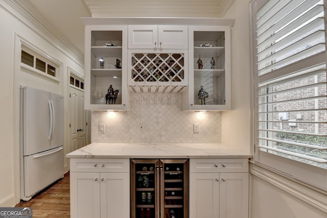 8230 Royal Melbourne Way, Duluth, GA 30097 - indoor dry bar featuring freestanding refrigerator, beverage cooler, decorative backsplash, light wood finished floors, and ornamental molding