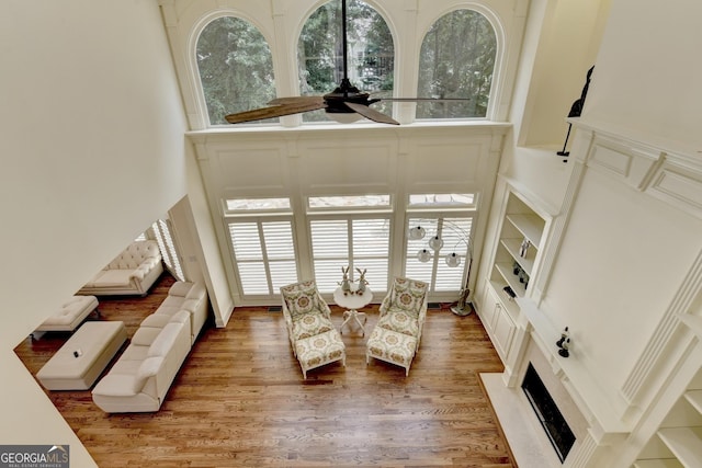 8230 Royal Melbourne Way, Duluth, GA 30097 - dining area with a towering ceiling, a ceiling fan, wood finished floors, and a premium fireplace