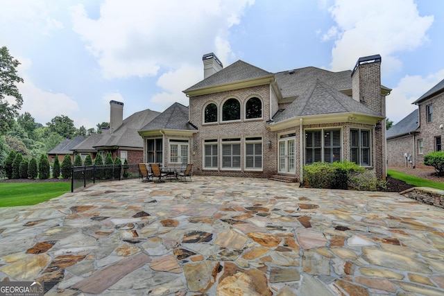 8230 Royal Melbourne Way, Duluth, GA 30097 - back of house with brick siding, a chimney, a patio area, and roof with shingles