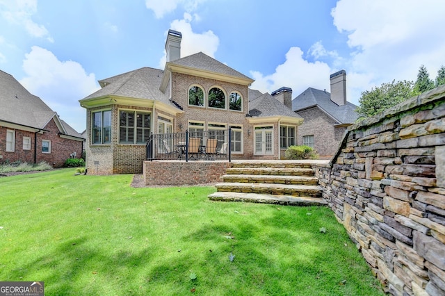 8230 Royal Melbourne Way, Duluth, GA 30097 - back of house with brick siding, a lawn, and a chimney