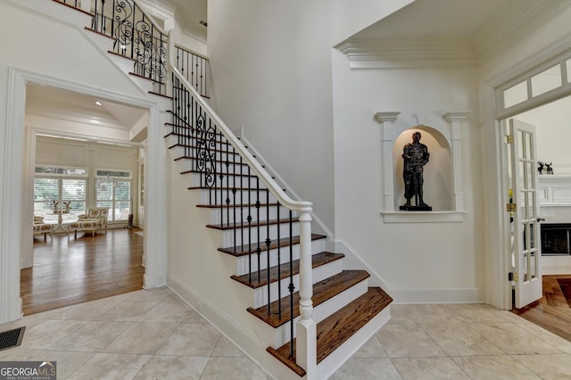 8230 Royal Melbourne Way, Duluth, GA 30097 - stairs featuring a high ceiling, ornamental molding, and tile patterned floors