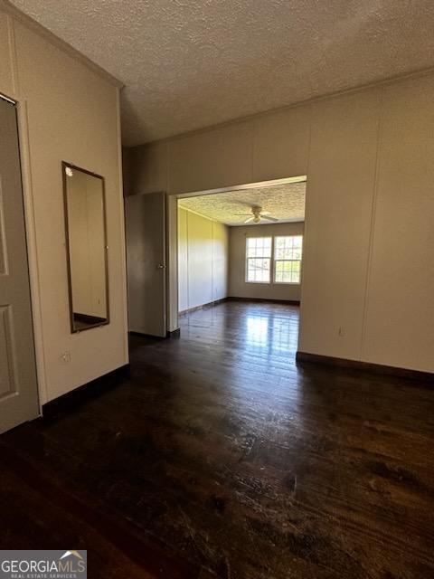 3171 Wagnon Mill Rd, Bishop, GA 30621 - spare room featuring dark wood-style flooring, a textured ceiling, and a ceiling fan