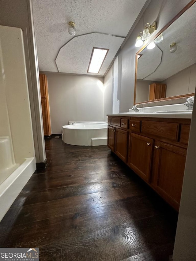 3171 Wagnon Mill Rd, Bishop, GA 30621 - full bath with a garden tub, vanity, hardwood / wood-style floors, and a textured ceiling