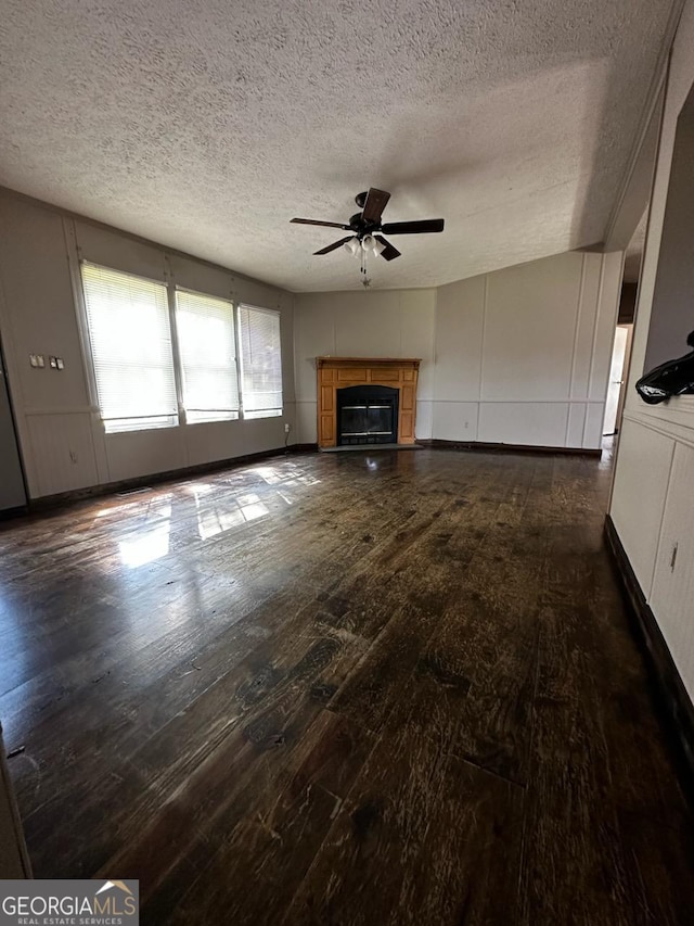 3171 Wagnon Mill Rd, Bishop, GA 30621 - unfurnished living room featuring a ceiling fan, dark wood-style floors, a glass covered fireplace, and a textured ceiling