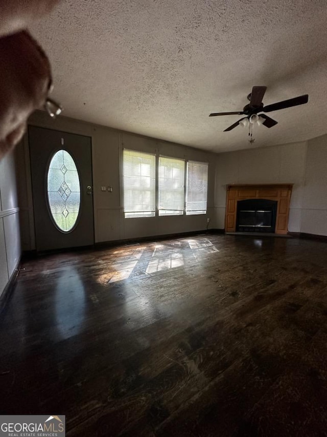 3171 Wagnon Mill Rd, Bishop, GA 30621 - unfurnished living room with a ceiling fan, a textured ceiling, a glass covered fireplace, and wood finished floors
