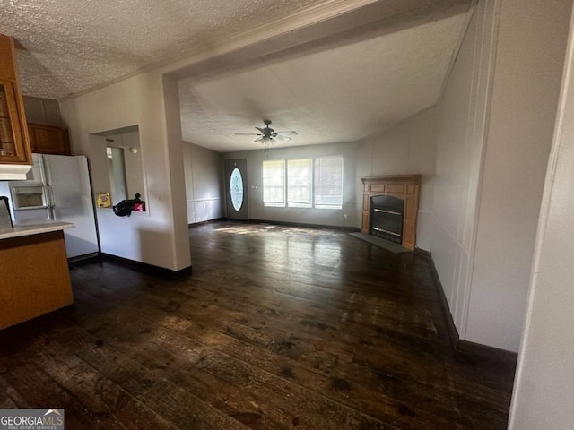 3171 Wagnon Mill Rd, Bishop, GA 30621 - unfurnished living room featuring dark wood-style flooring, a ceiling fan, a textured ceiling, and a glass covered fireplace
