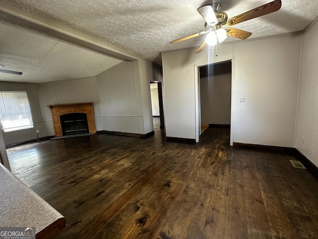 3171 Wagnon Mill Rd, Bishop, GA 30621 - unfurnished living room with dark wood-style flooring, a textured ceiling, ceiling fan, and a fireplace