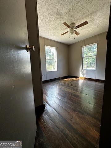 3171 Wagnon Mill Rd, Bishop, GA 30621 - unfurnished room with plenty of natural light, ceiling fan, dark wood finished floors, and a textured ceiling