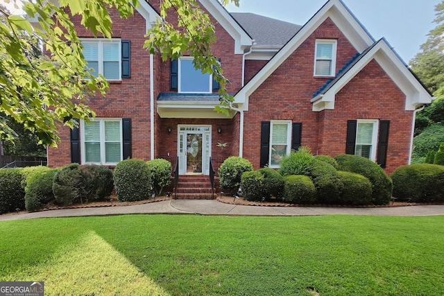 1205 Runnelwood Trl, Snelville, GA 30078 - view of front of home featuring a front yard, brick siding, and a shingled roof