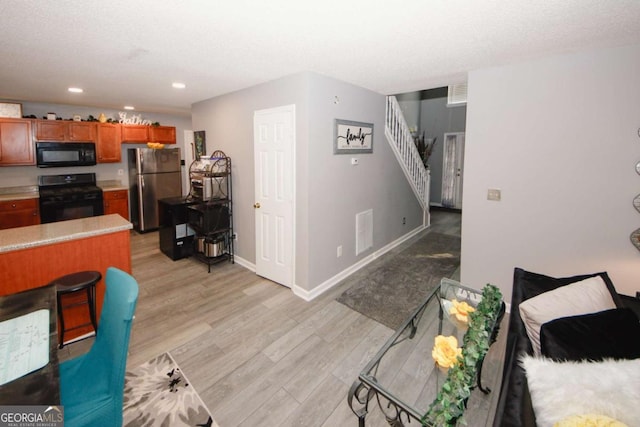 1964 Cutters Mill Way, Lithonia, GA 30058 - living room featuring stairway, light wood-style flooring, and recessed lighting