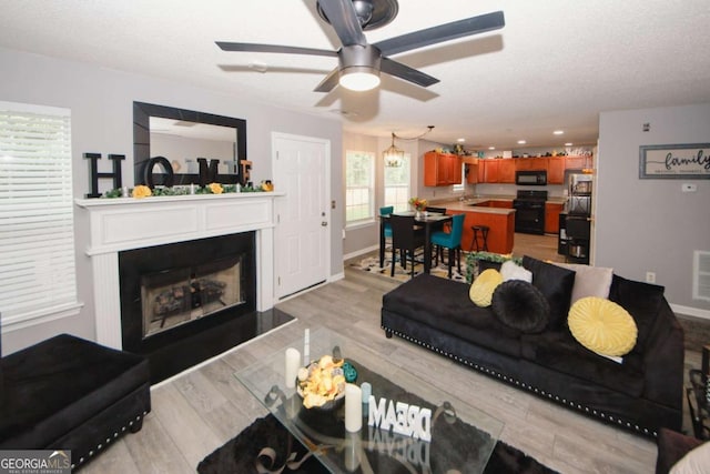 1964 Cutters Mill Way, Lithonia, GA 30058 - living area featuring ceiling fan, light wood-style floors, a fireplace, and recessed lighting