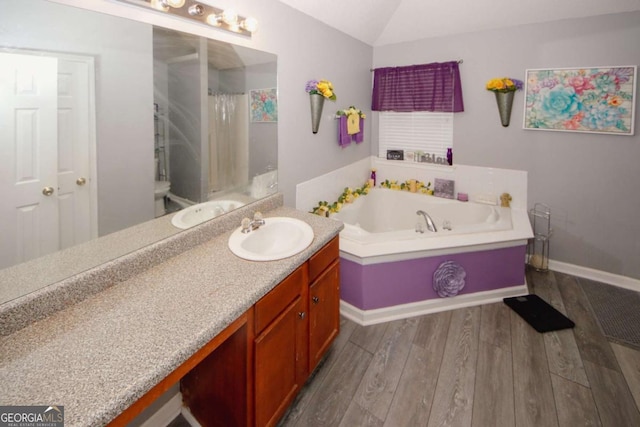 1964 Cutters Mill Way, Lithonia, GA 30058 - full bathroom featuring vanity, a bath, wood finished floors, curtained shower, and vaulted ceiling