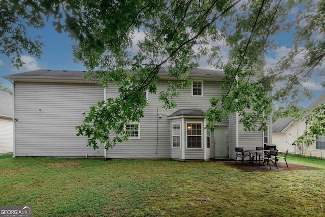 1964 Cutters Mill Way, Lithonia, GA 30058 - rear view of house featuring a lawn and a patio area