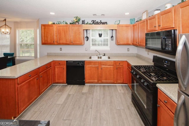 1964 Cutters Mill Way, Lithonia, GA 30058 - kitchen featuring black appliances, a peninsula, light wood-type flooring, a chandelier, and recessed lighting
