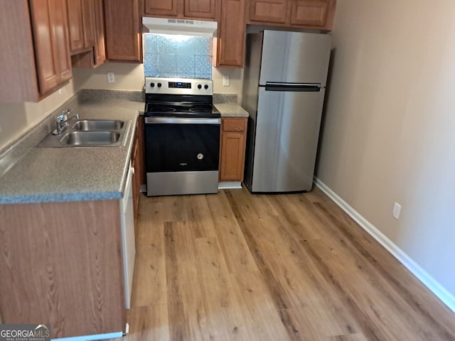 41 Middlebrook Dr, Cartersville, GA 30120 - kitchen featuring appliances with stainless steel finishes, under cabinet range hood, light wood finished floors, brown cabinetry, and light countertops