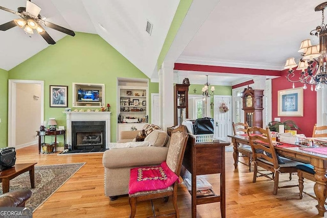 262 Pinnacle Pointe Dr, Rocky Face, GA 30740 - living room with a chandelier, a ceiling fan, a fireplace, light wood-style floors, and built in shelves