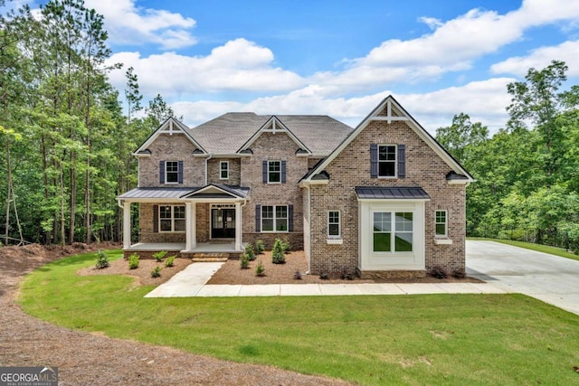 7449 Waterview Cv, Douglasville, GA 30135 - craftsman inspired home with a standing seam roof, a porch, a front lawn, brick siding, and a metal roof