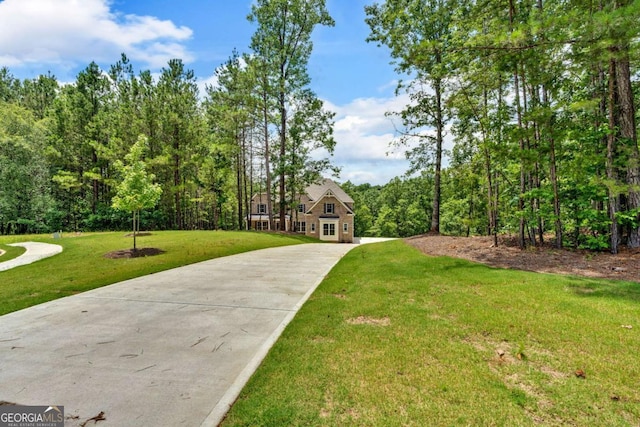 7449 Waterview Cv, Douglasville, GA 30135 - view of front of property featuring concrete driveway, a front yard, and a view of trees