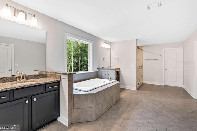 7449 Waterview Cv, Douglasville, GA 30135 - bathroom with vanity, a garden tub, and a shower stall