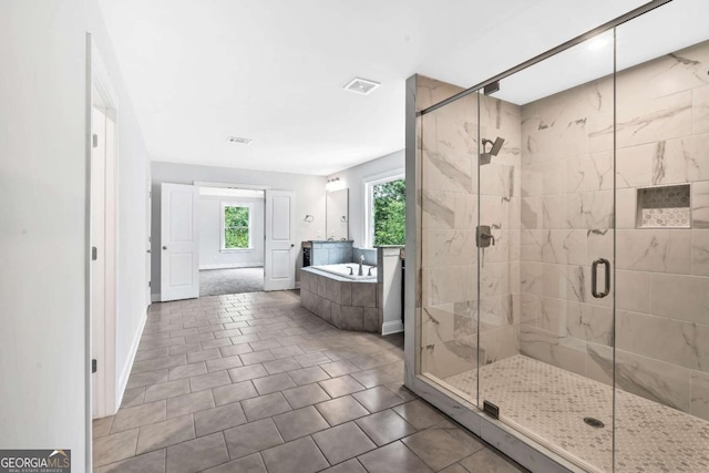 7449 Waterview Cv, Douglasville, GA 30135 - bathroom with a bath, a shower stall, and tile patterned floors