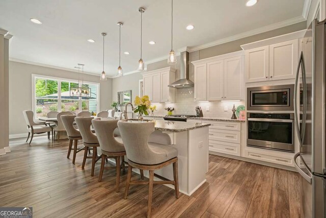 287 Flower Farm Dr, Acworth, GA 30101 - kitchen featuring stainless steel appliances, wall chimney exhaust hood, decorative backsplash, light stone counters, and white cabinetry