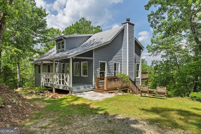832 Round Top Dr, Clayton, GA 30525 - rear view of house featuring a chimney, a lawn, and a deck