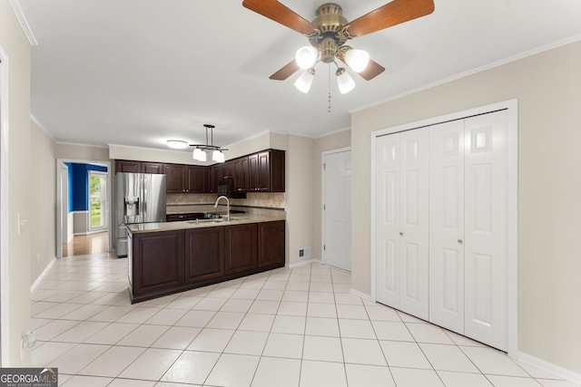 1655 Oak Crest Ct, Marietta, GA 30066 - kitchen with stainless steel fridge, light countertops, a peninsula, dark brown cabinetry, and ornamental molding
