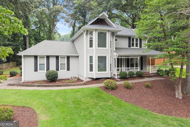 1655 Oak Crest Ct, Marietta, GA 30066 - victorian home with covered porch, roof with shingles, and a front yard