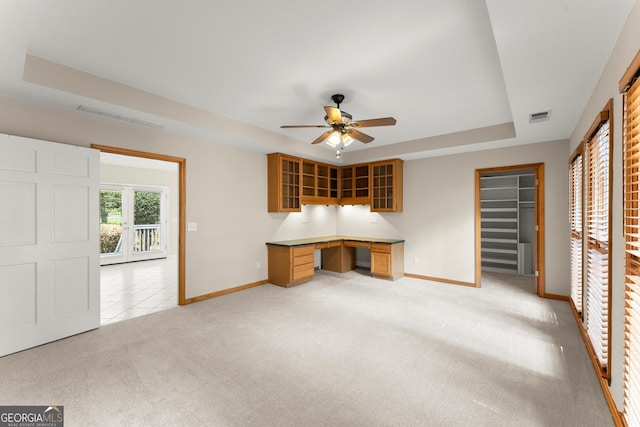 1655 Oak Crest Ct, Marietta, GA 30066 - unfurnished living room with ceiling fan, a tray ceiling, built in desk, and light carpet