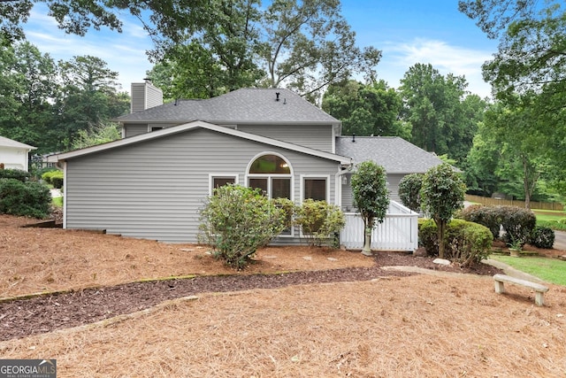 1655 Oak Crest Ct, Marietta, GA 30066 - view of home's exterior with a chimney and a shingled roof