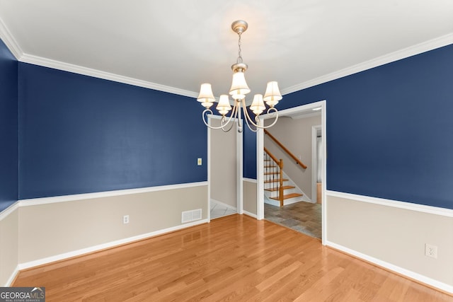1655 Oak Crest Ct, Marietta, GA 30066 - spare room featuring a chandelier, wood finished floors, ornamental molding, and stairs