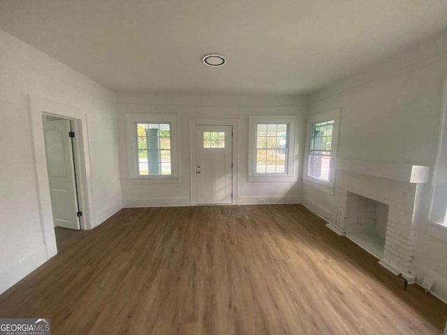 1097 Edna Pl, Macon, GA 31204 - unfurnished living room with wood finished floors and a fireplace
