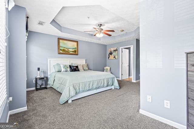 3832 Augustine Pl, Rex, GA 30273 - carpeted bedroom featuring a tray ceiling, a textured ceiling, and ceiling fan