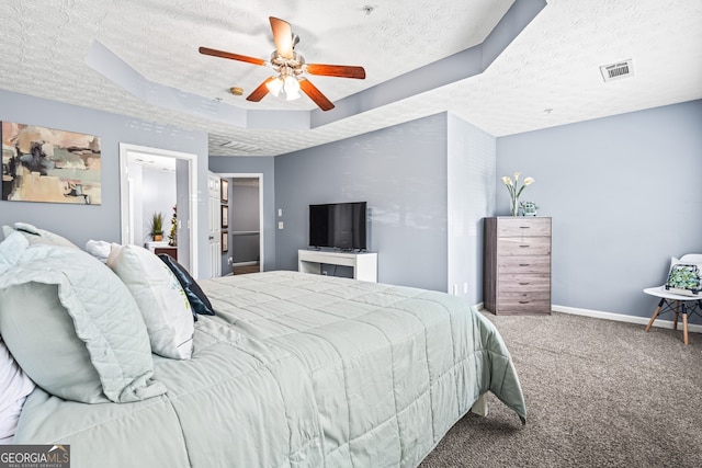 3832 Augustine Pl, Rex, GA 30273 - carpeted bedroom featuring a textured ceiling, a ceiling fan, and a tray ceiling