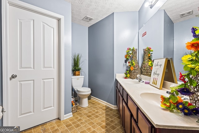 3832 Augustine Pl, Rex, GA 30273 - bathroom featuring double vanity, tile patterned floors, and a textured ceiling