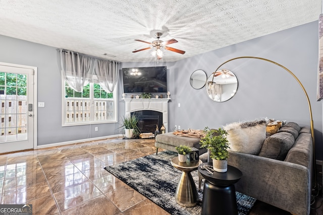 3832 Augustine Pl, Rex, GA 30273 - living room with plenty of natural light, ceiling fan, a fireplace, a textured ceiling, and marble tiled floors