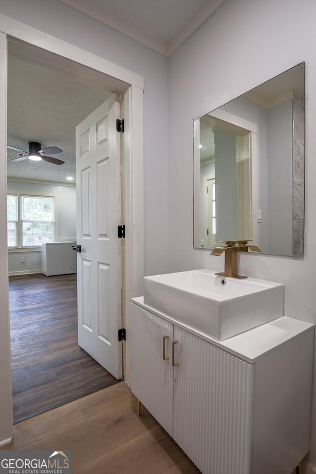 7144 Carolyn Cir, Lithia Springs, GA 30122 - bathroom with wood finished floors, vanity, ceiling fan, and ornamental molding