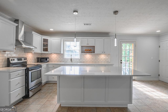 7144 Carolyn Cir, Lithia Springs, GA 30122 - kitchen with stainless steel electric stove, wall chimney range hood, black microwave, a kitchen island, and decorative backsplash